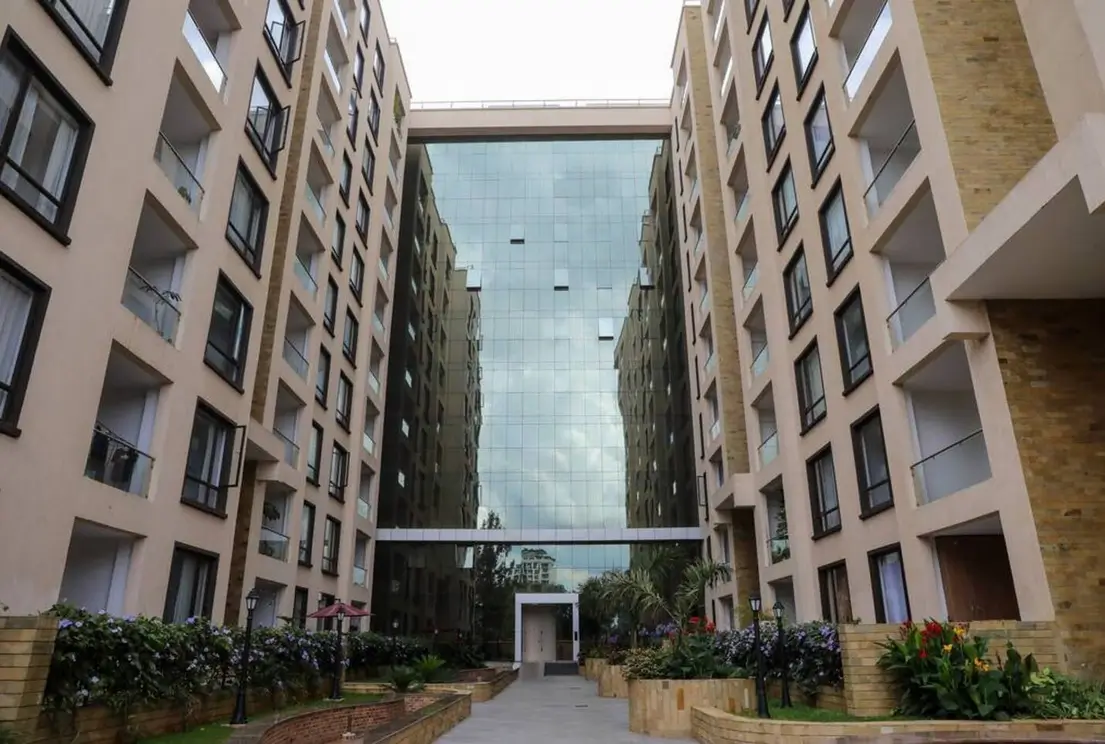 Modern residential complex courtyard with landscaping and sky bridge