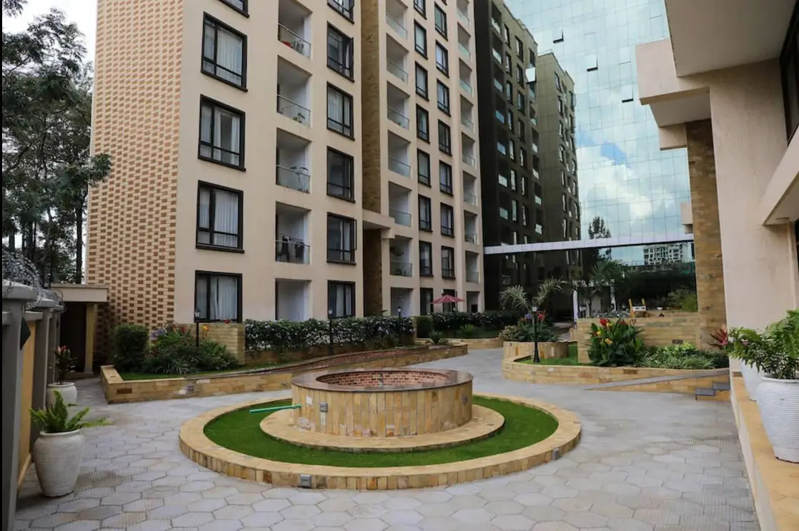 Compound courtyard with central firepit and manicured lawn