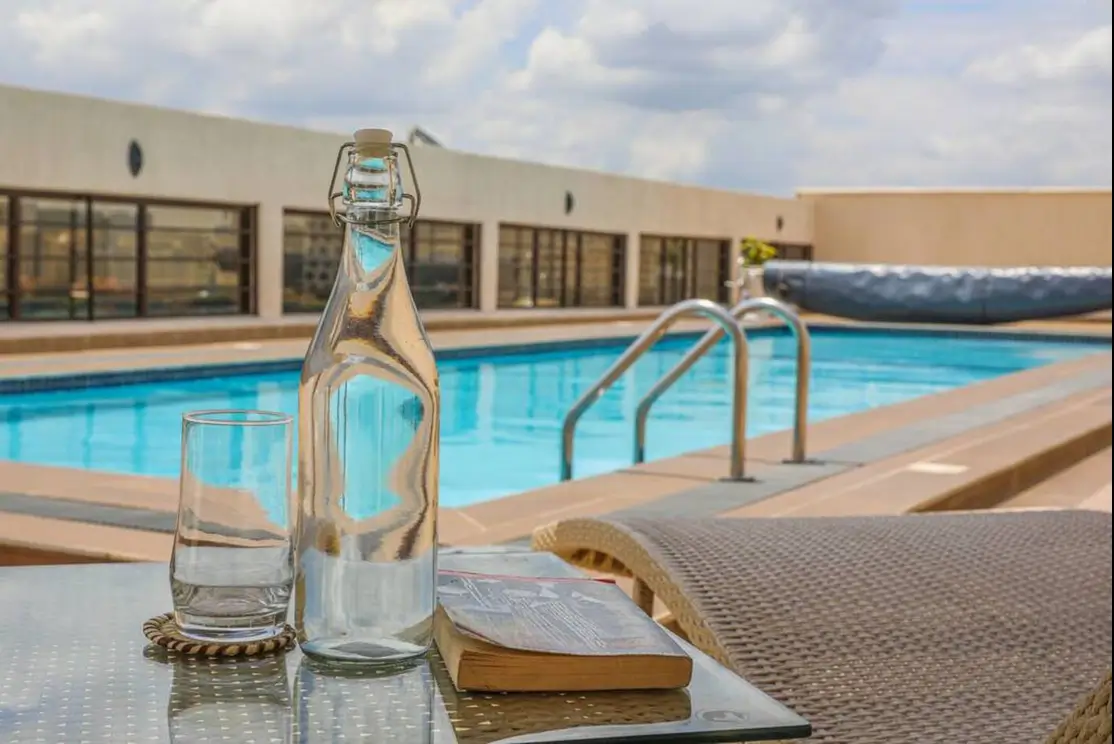 Resort-style swimming pool with loungers and modern deck area
