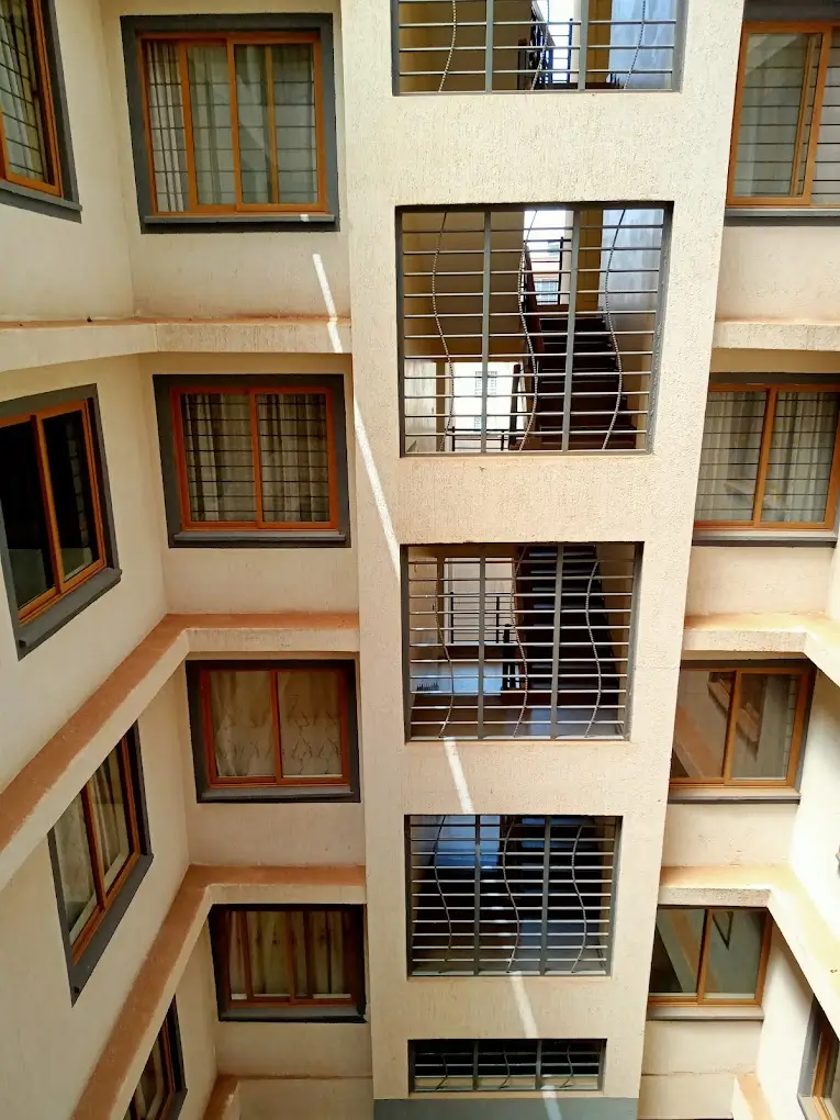 Multi-story residential building interior courtyard with stairwell