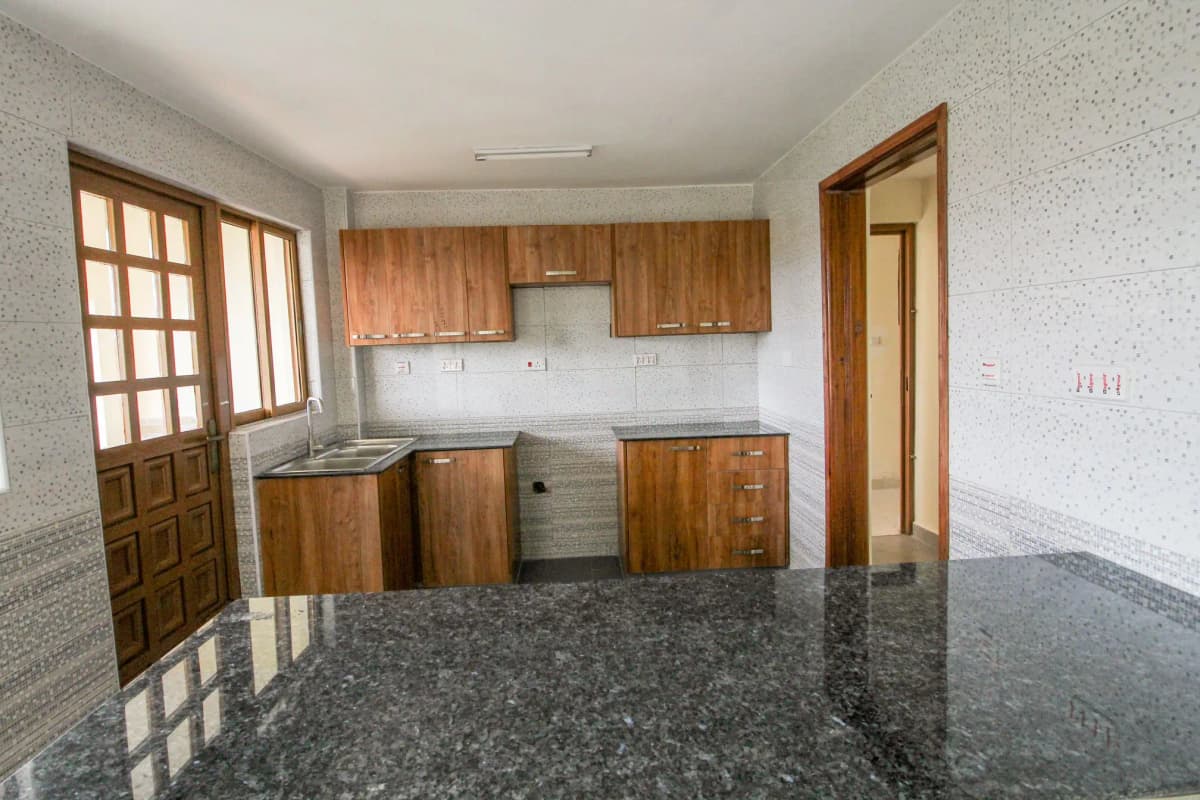 Spacious kitchen with wooden cabinets and granite countertop
