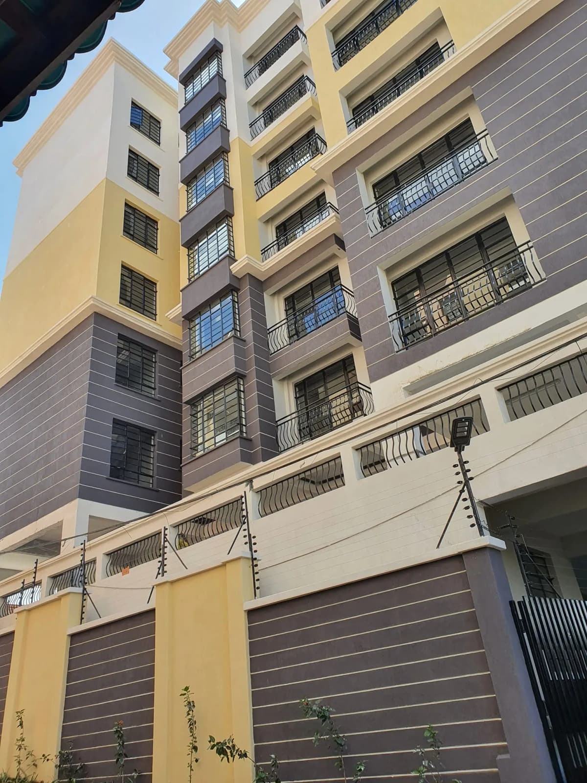 Multi-story residential building facade with balconies and garage
