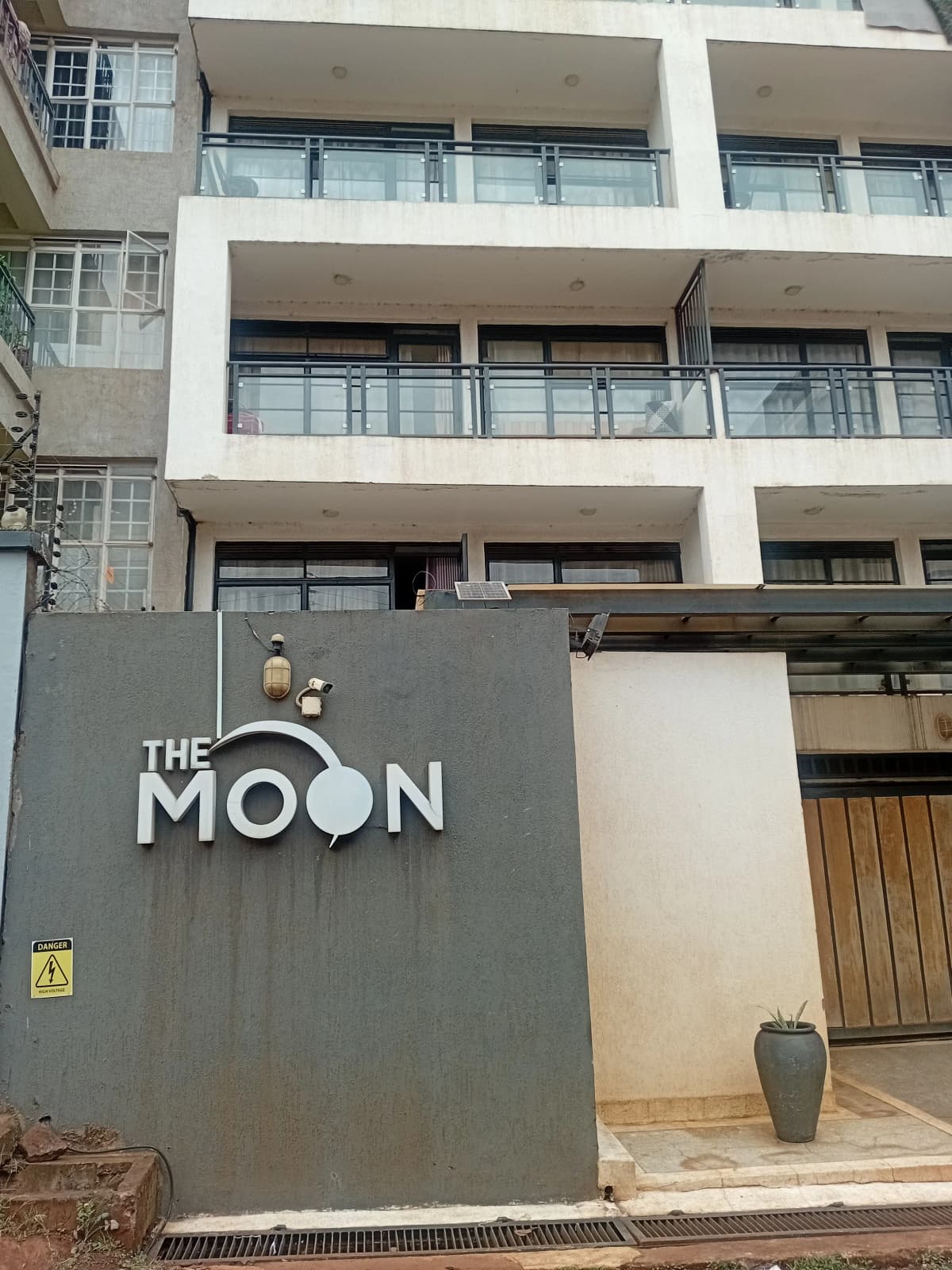 Modern apartment building facade with branded entrance gate