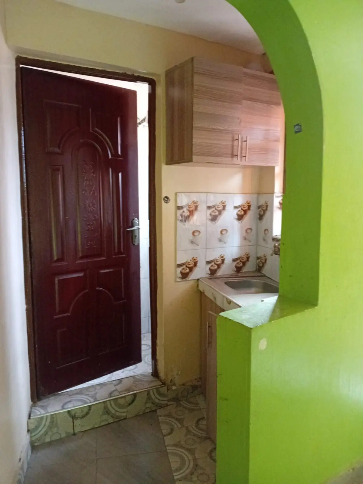 Compact kitchen with decorative backtile and bright lime green walls