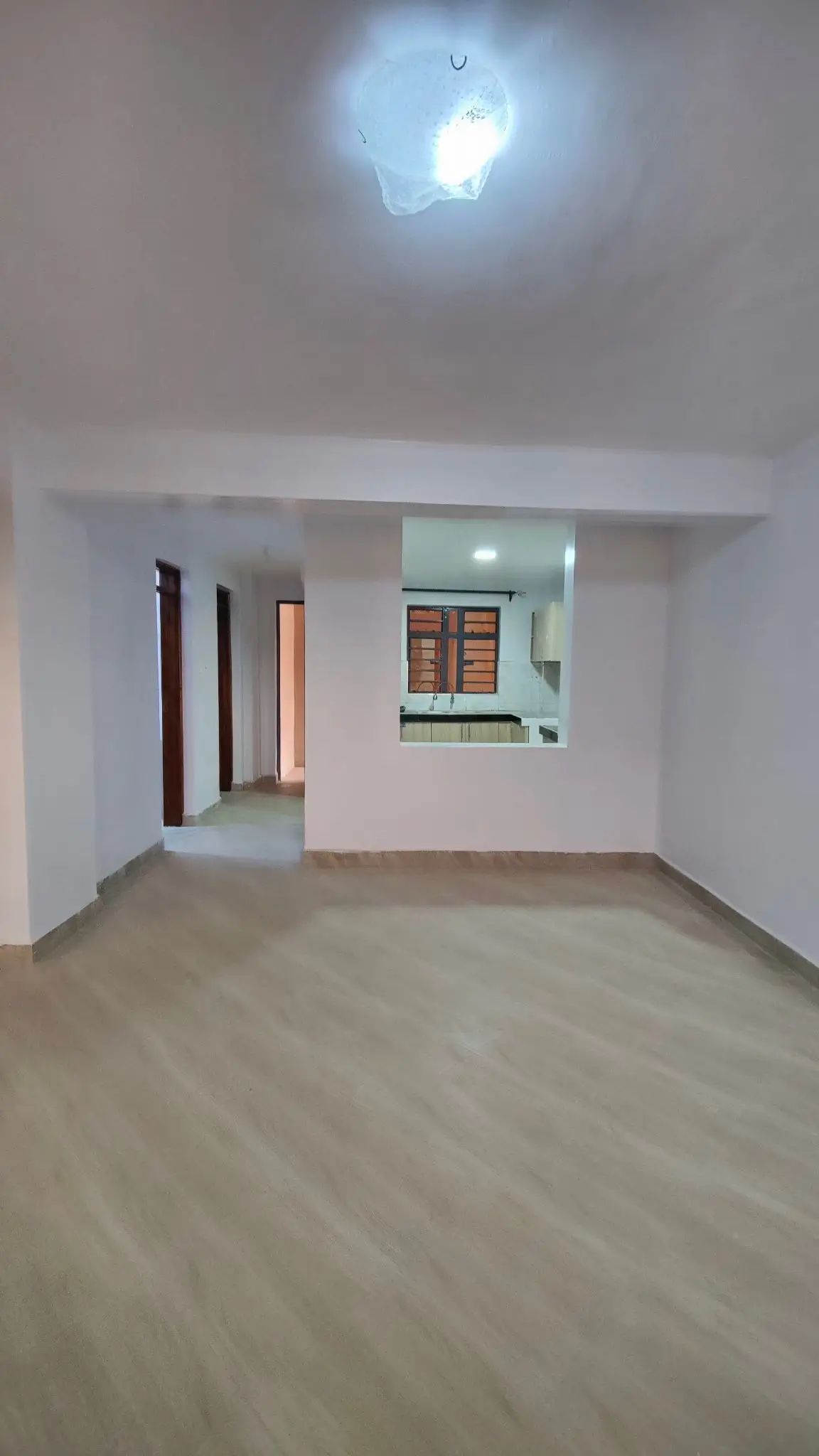 Spacious empty living room with polished concrete floor