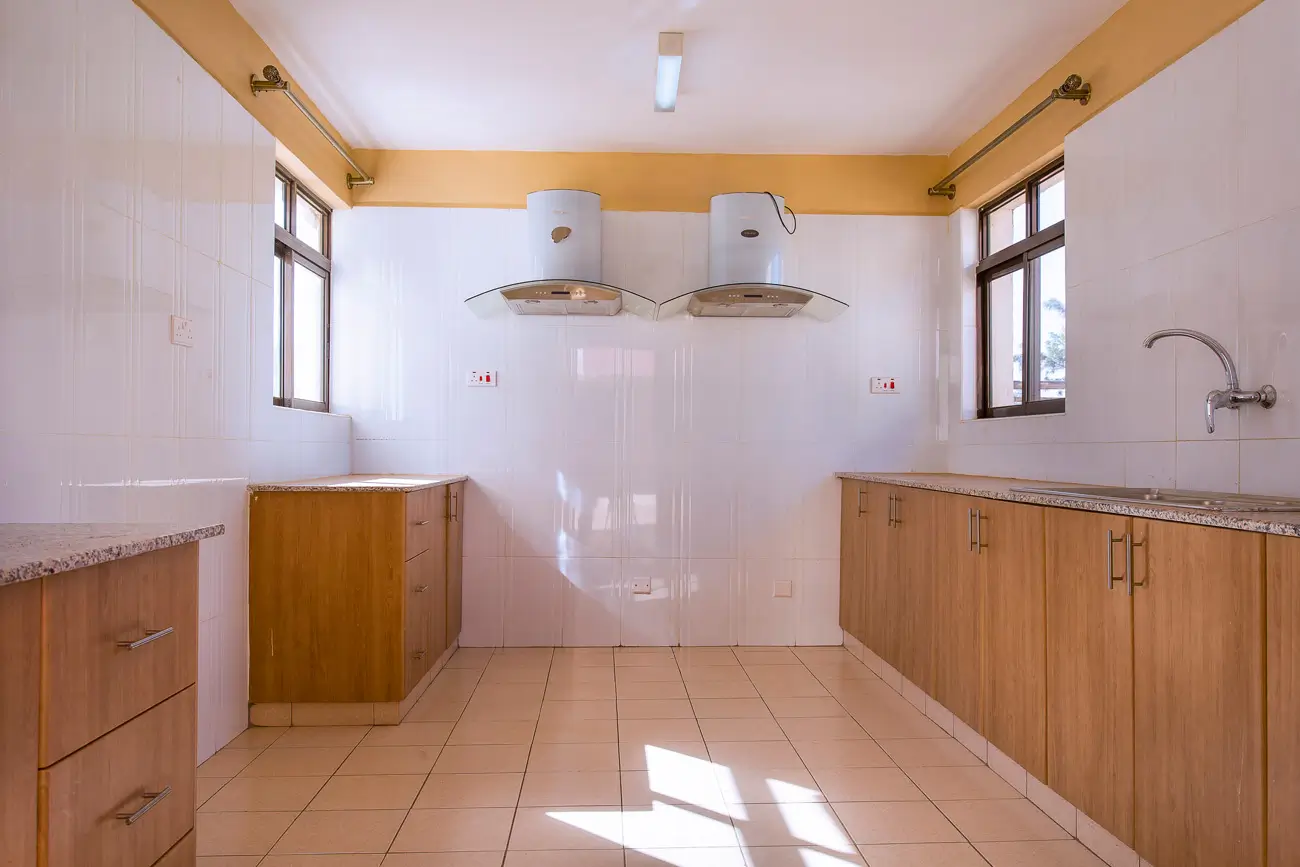 Spacious kitchen with wooden cabinetry and dual sinks