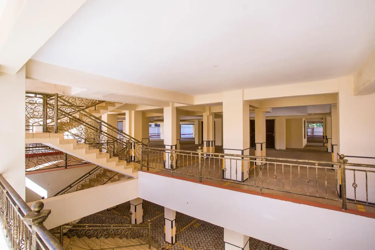 Multi-level building lobby with metal railings and staircase