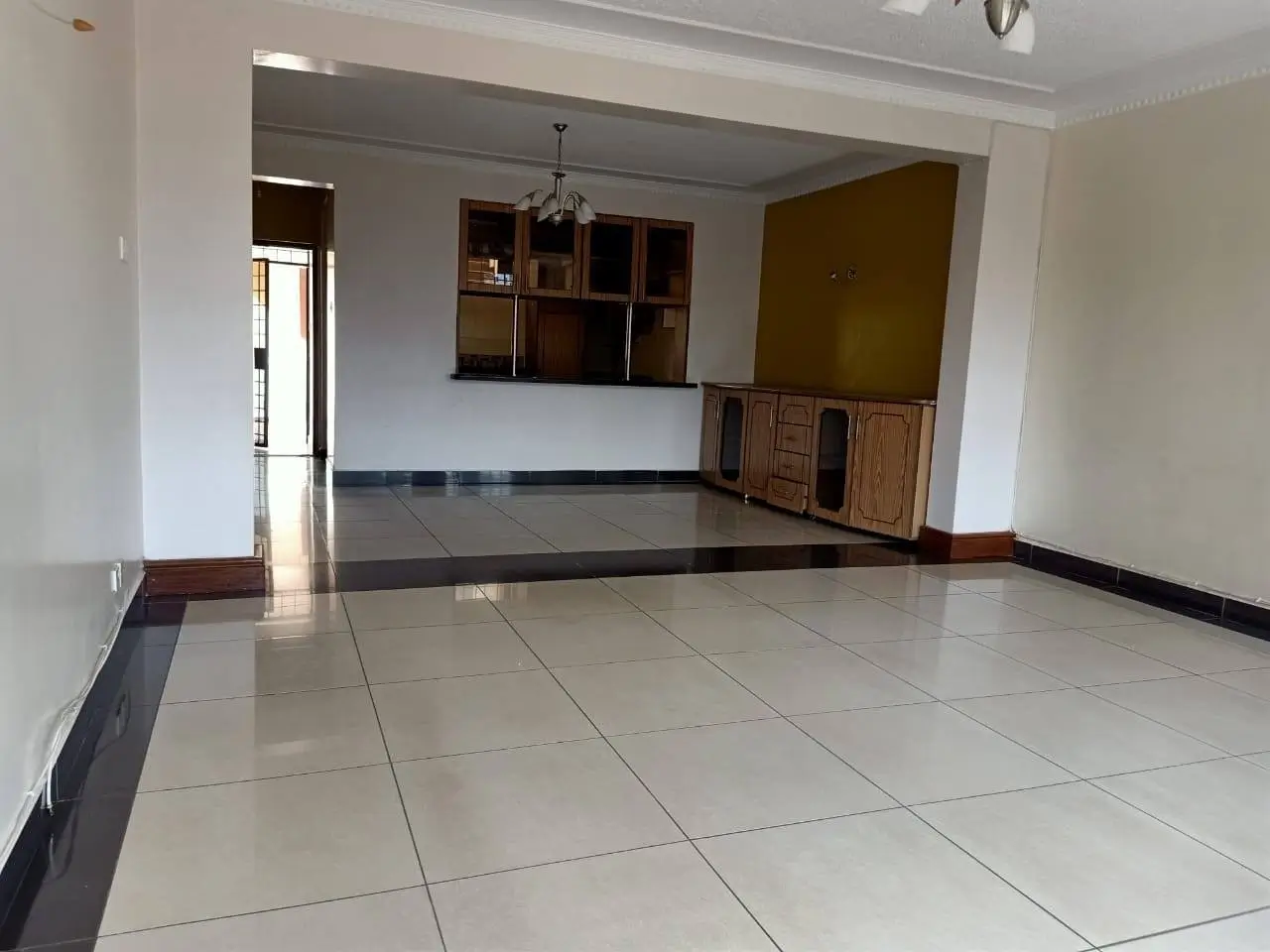 Open-plan living and kitchen area with tiled flooring