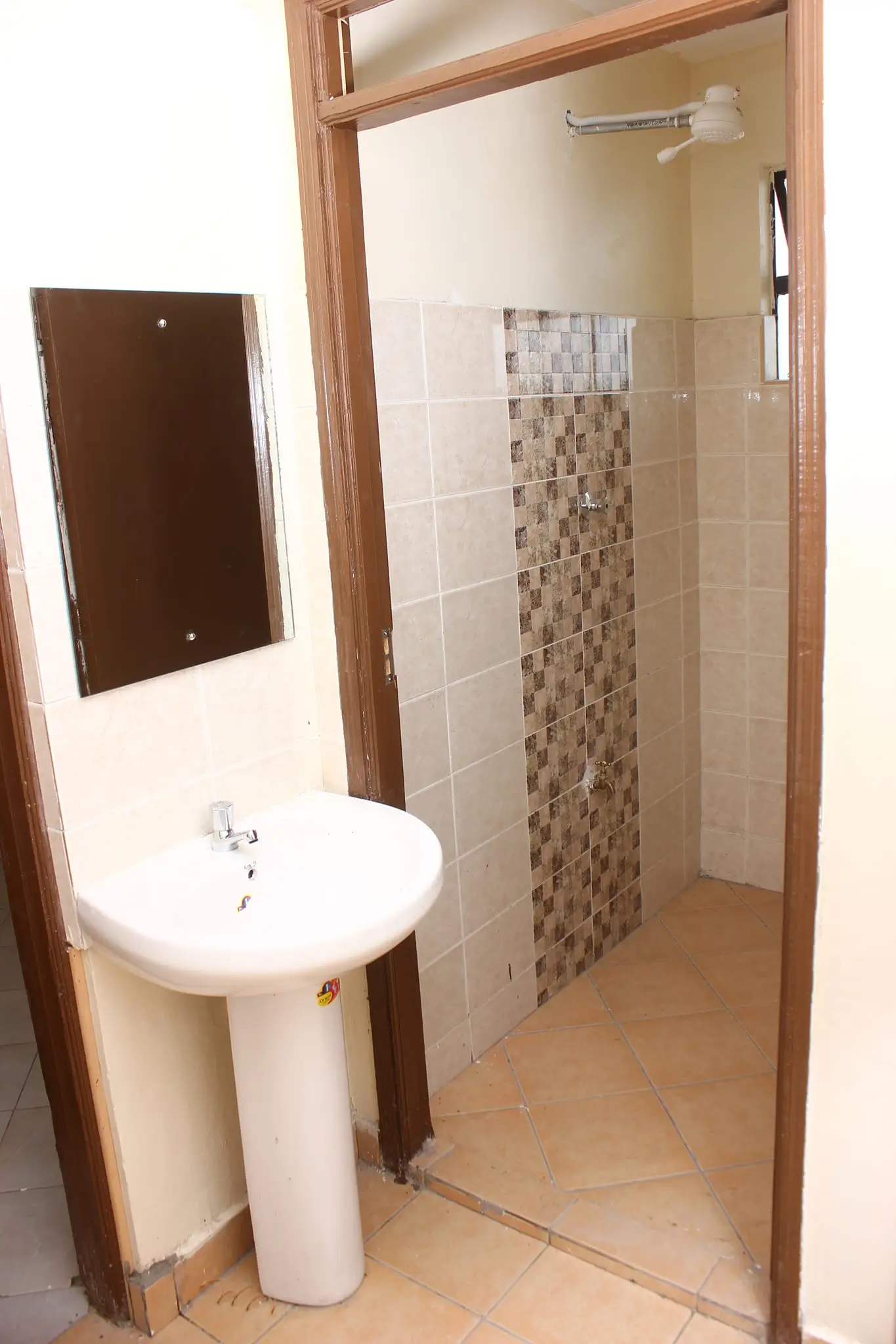 Compact bathroom with pedestal sink and walk-in shower