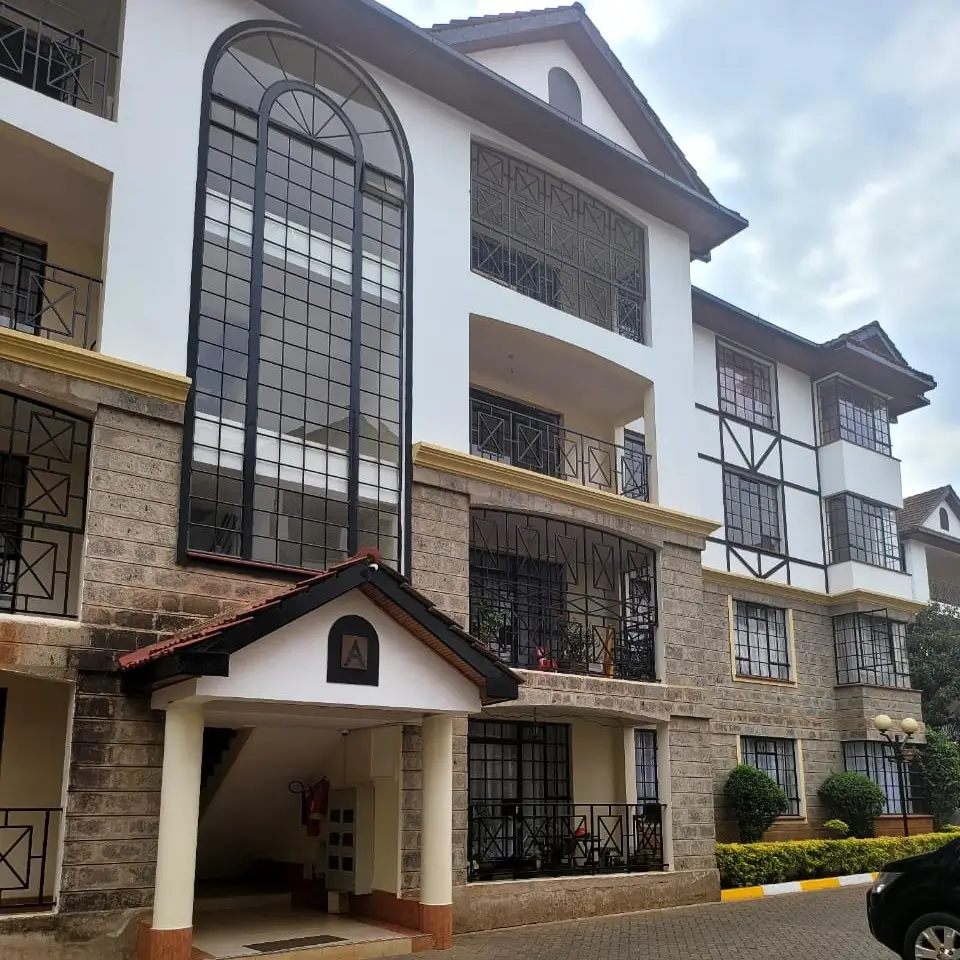 Modern multi-story residential building with stone and white facade