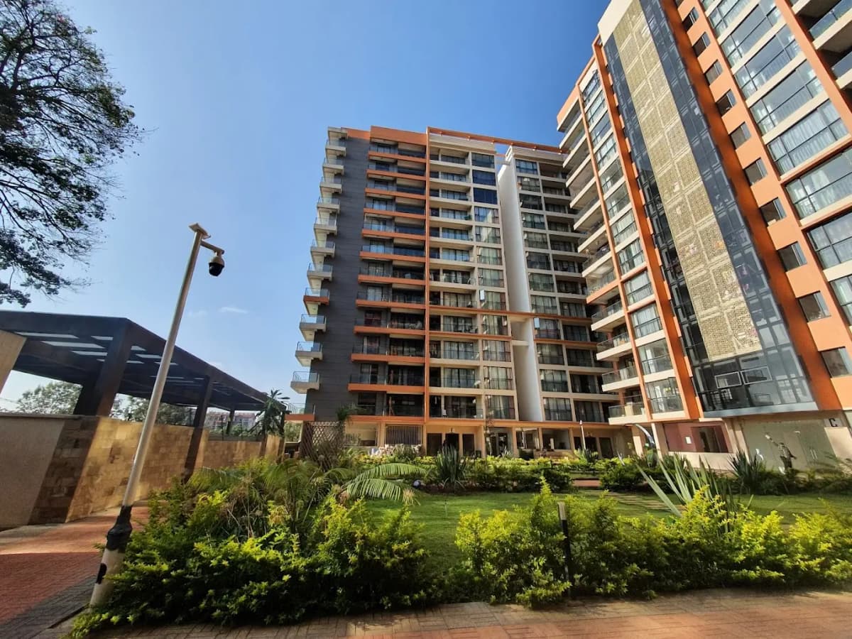 Modern apartment building with manicured compound grounds and landscaping