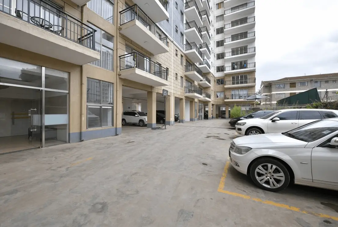Basement parking area with marked bays and building entrance