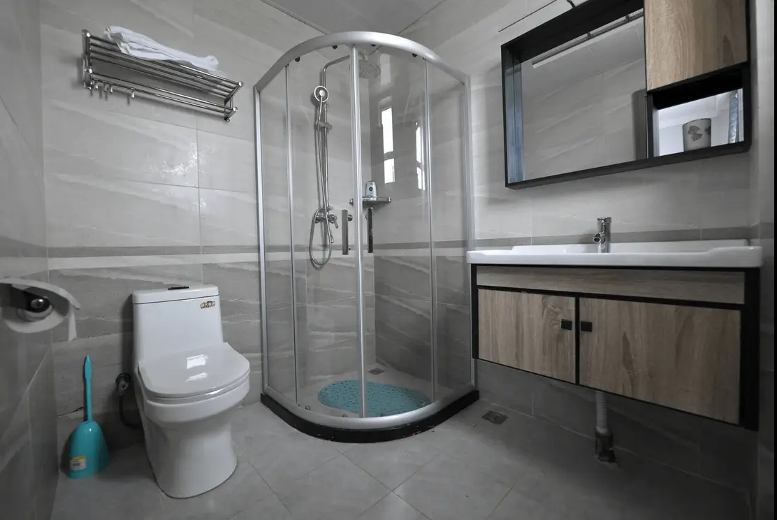 Modern bathroom with curved shower enclosure and vanity