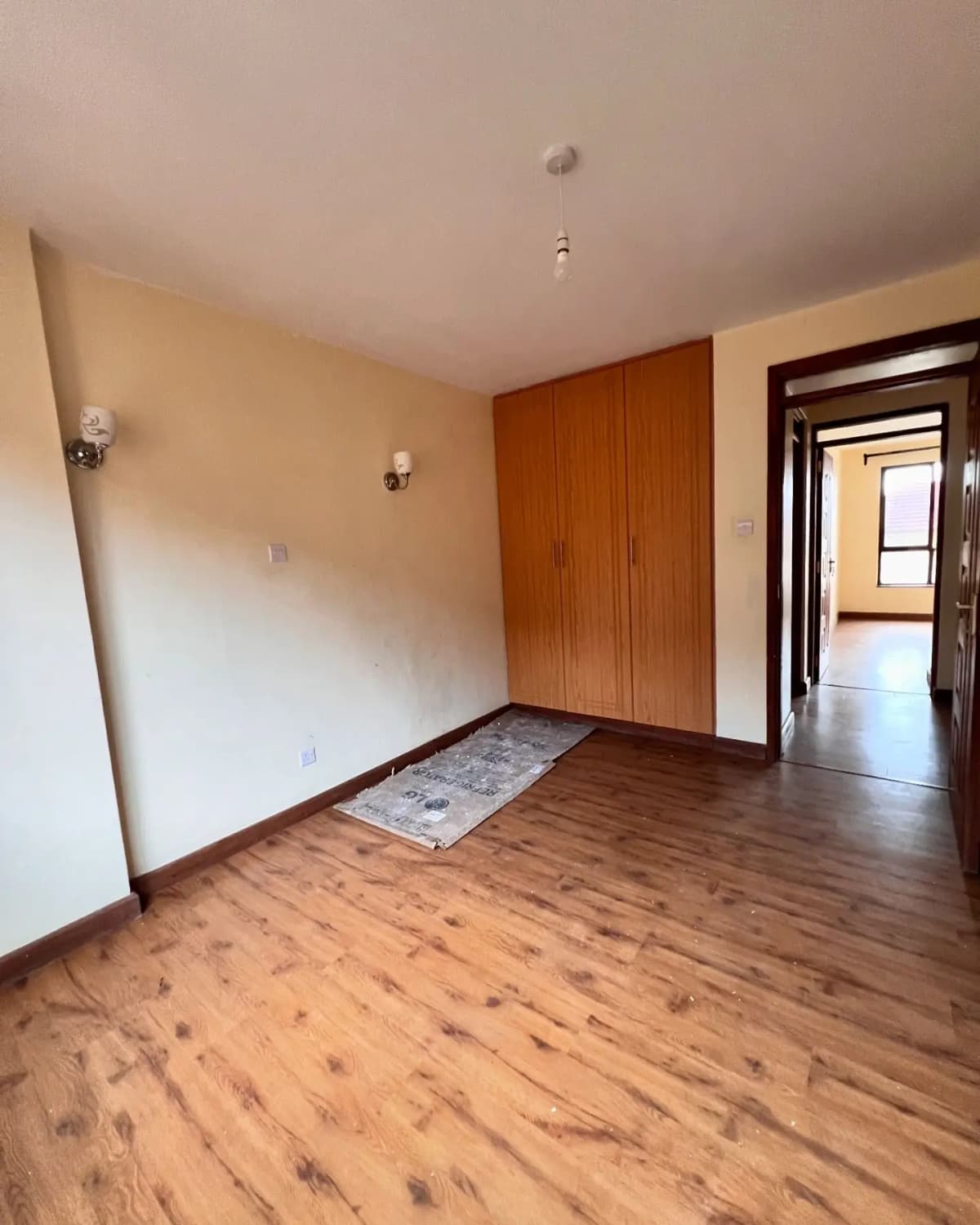Spacious bedroom with wooden flooring and built-in wardrobe
