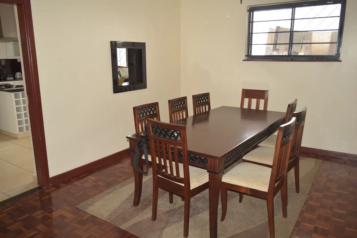 Formal dining room with wooden table and six chairs