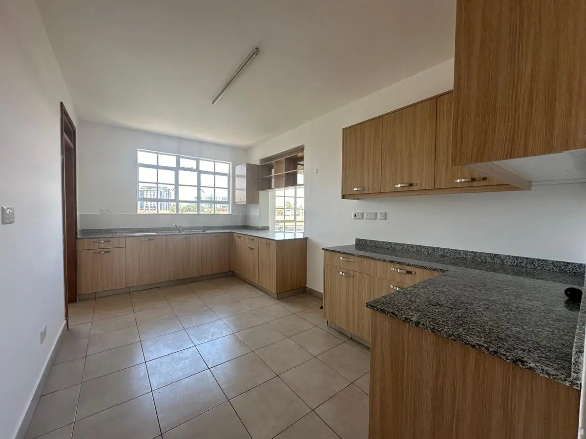 Spacious kitchen with wooden cabinetry and granite countertops