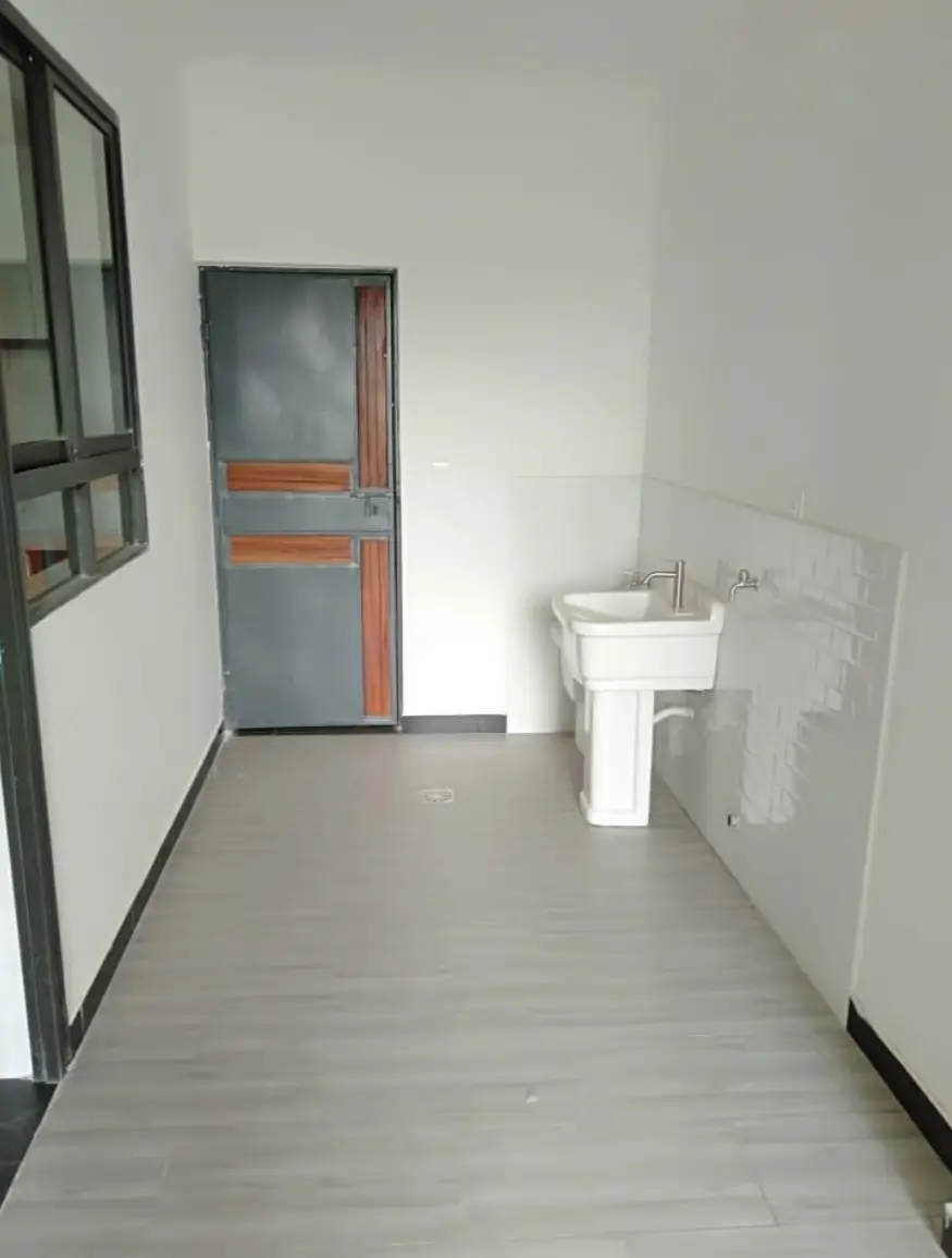Minimalist bathroom with pedestal sink and gray tile flooring