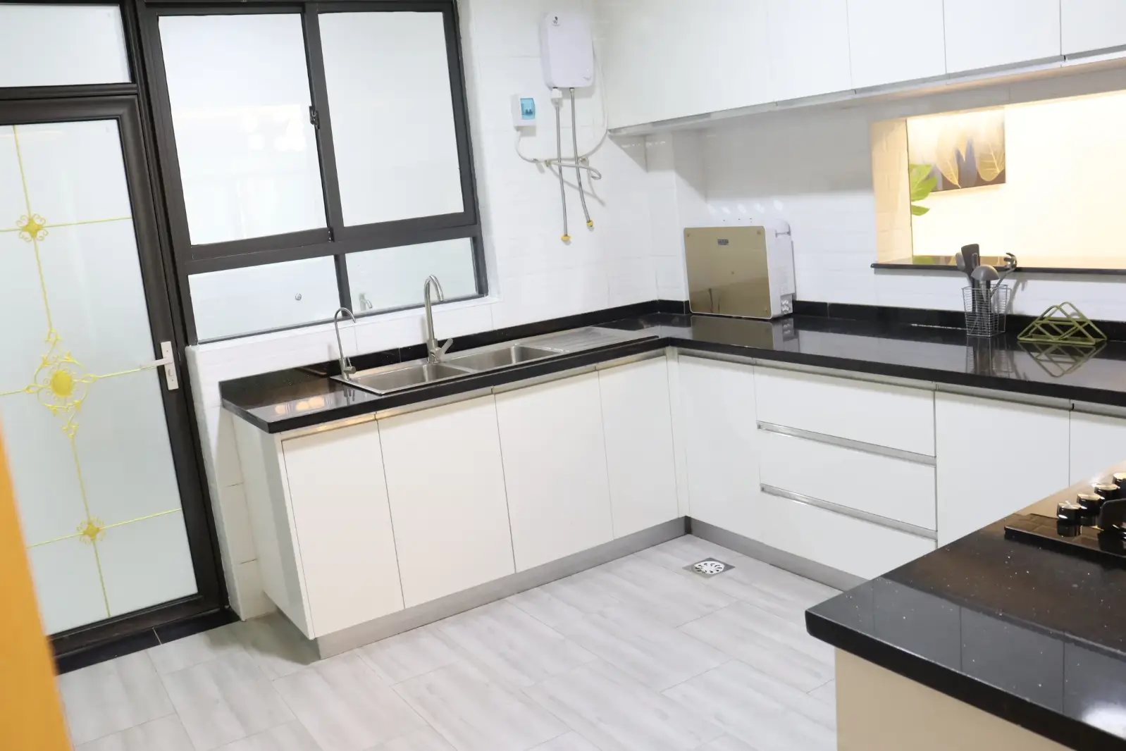 Modern white kitchen with black countertops and island