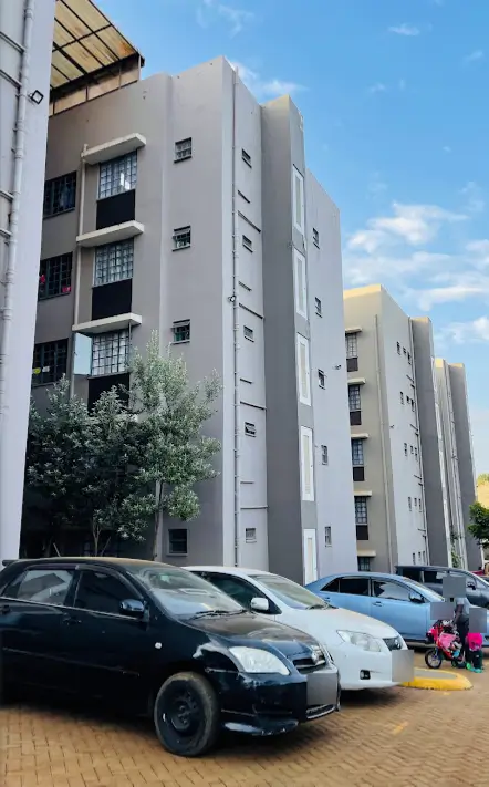 Modern apartment building facade with ground-level parking area
