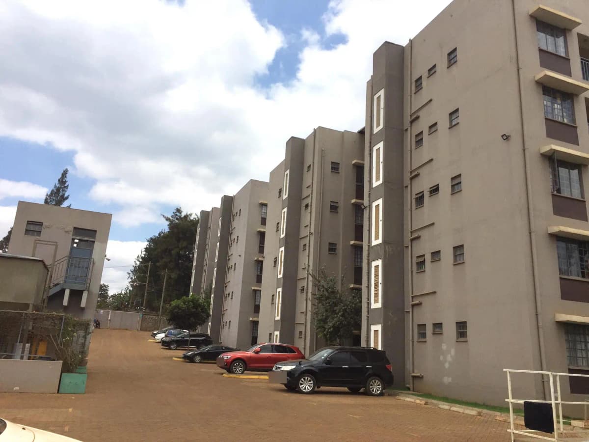 Multi-story residential building with parking compound and driveway