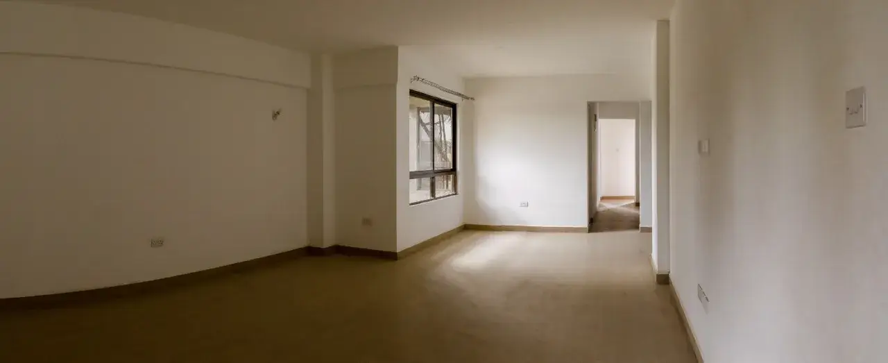 Spacious unfurnished open-plan living area with natural light
