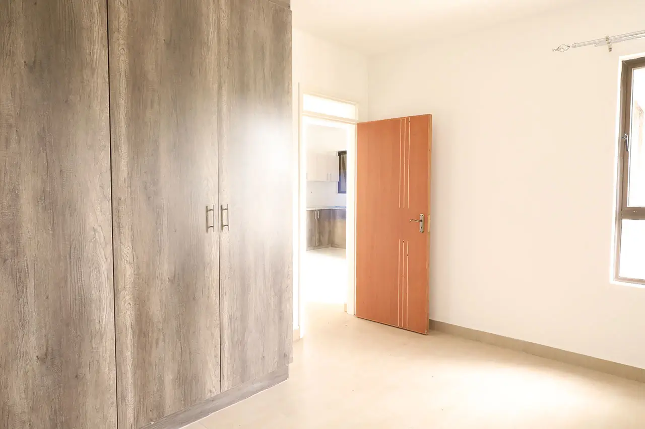 Spacious bedroom with built-in wardrobes and natural light