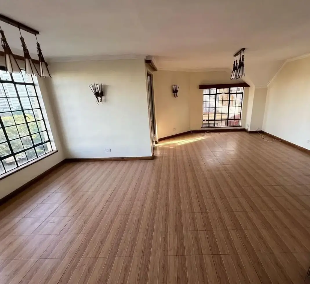 Spacious living room with wooden flooring and natural light