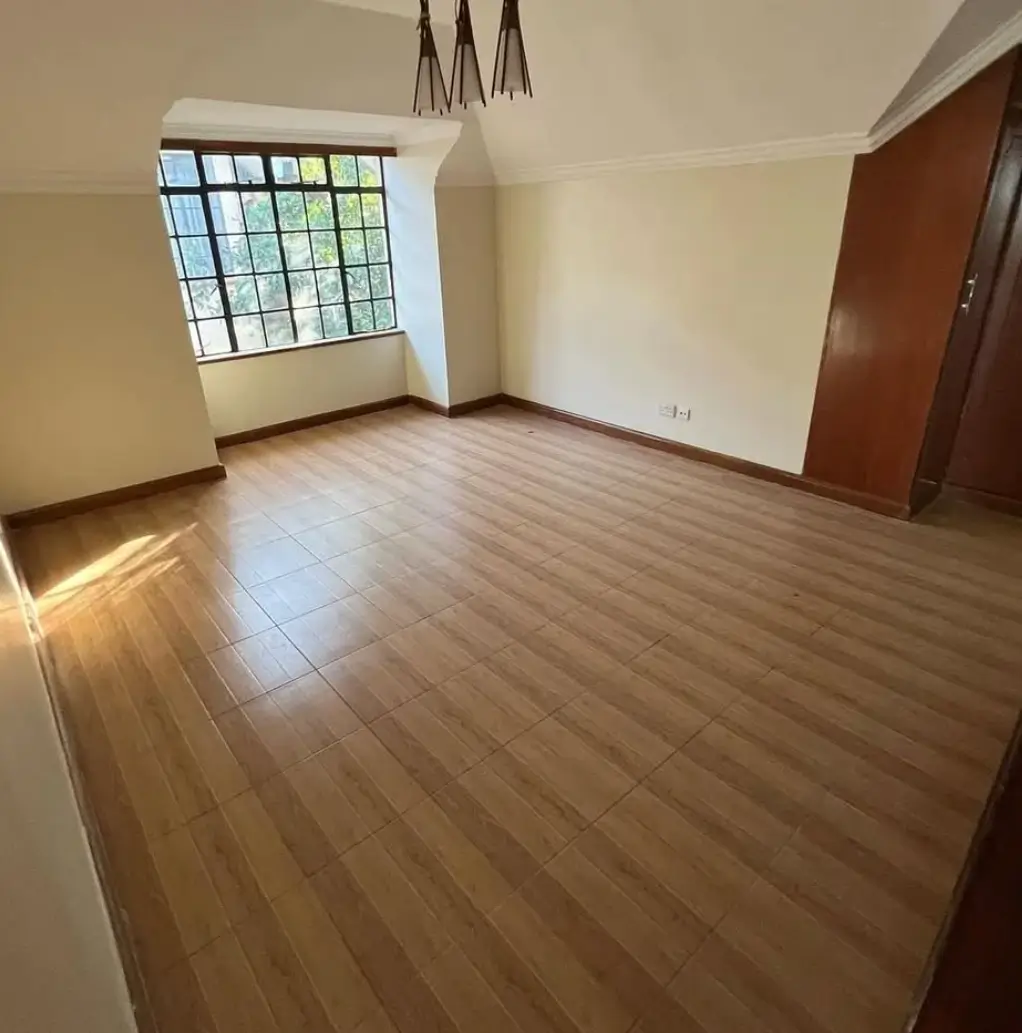 Spacious living room with wooden flooring and natural light