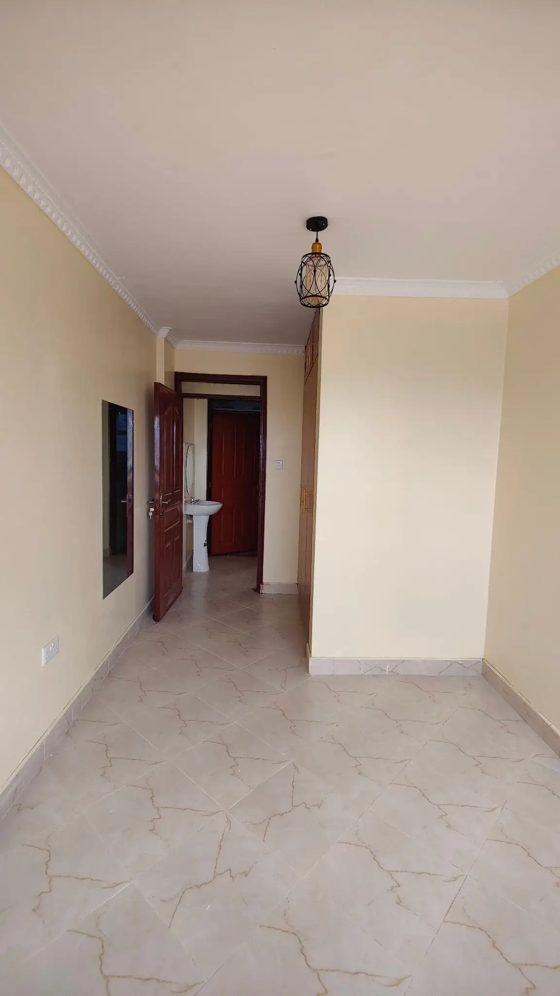 Empty corridor with marble flooring and wooden doors