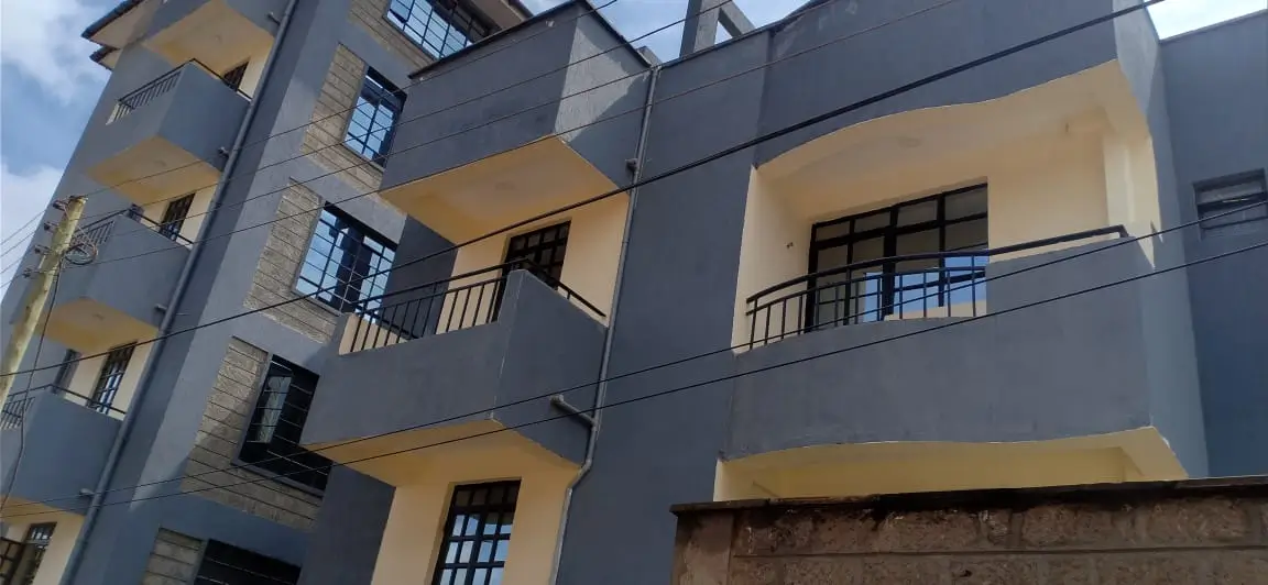Modern multi-story apartment building with yellow and dark gray facade