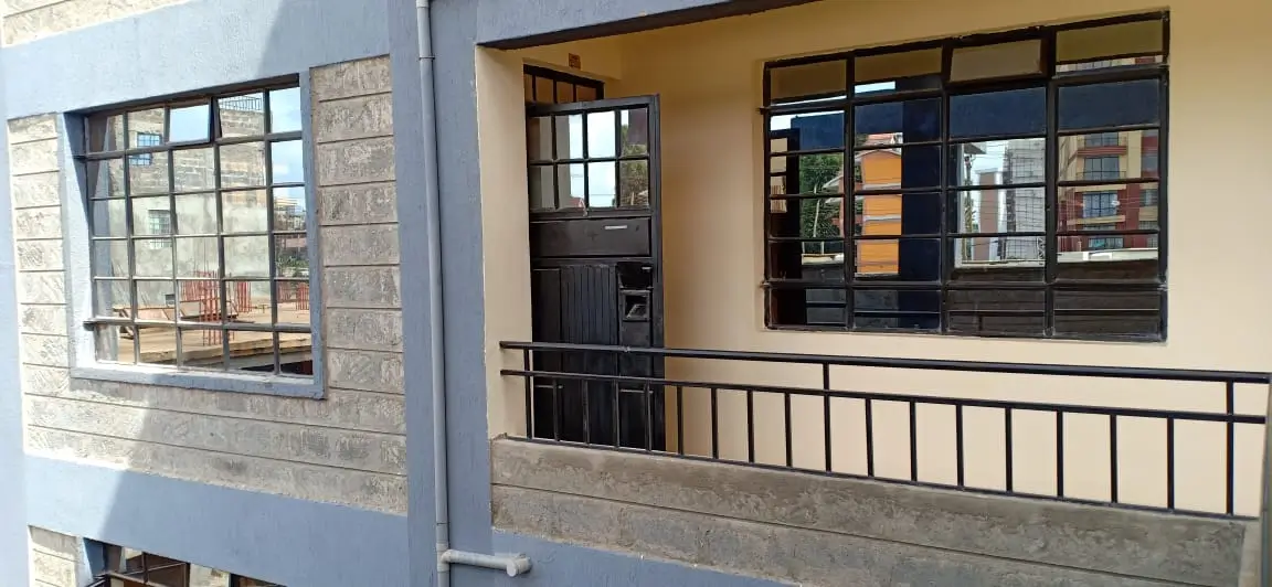 Modern apartment facade with balcony and large windows