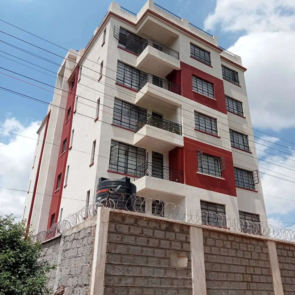 Modern multi-story residential building with red and white facade