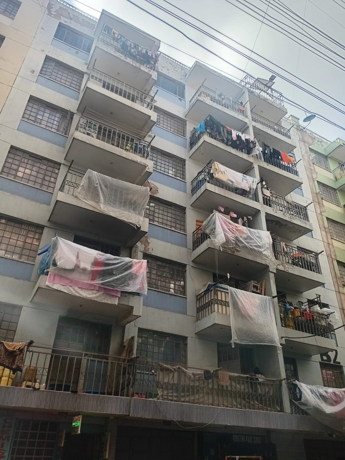 Multi-story residential building facade with balconies and laundry