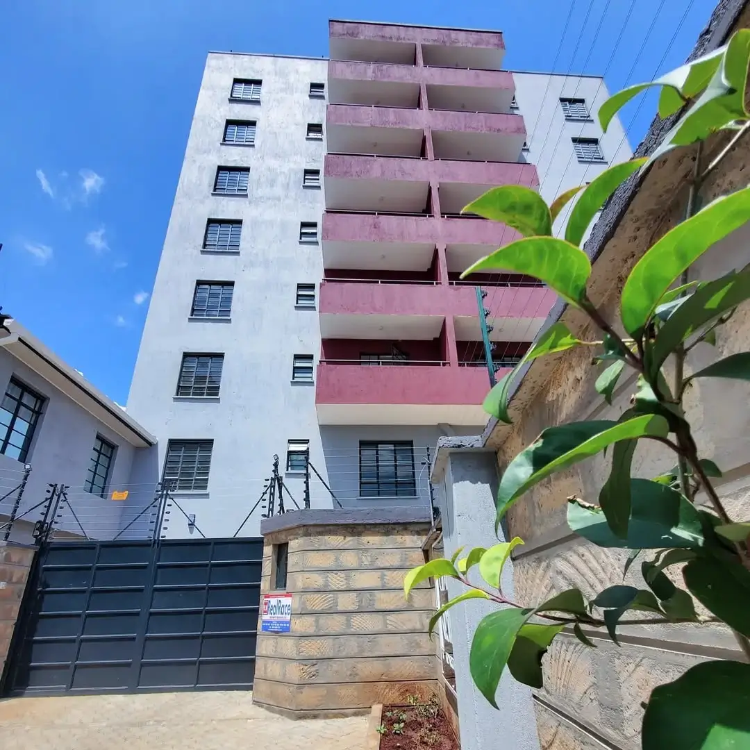 Multi-story residential building facade with balconies and gate