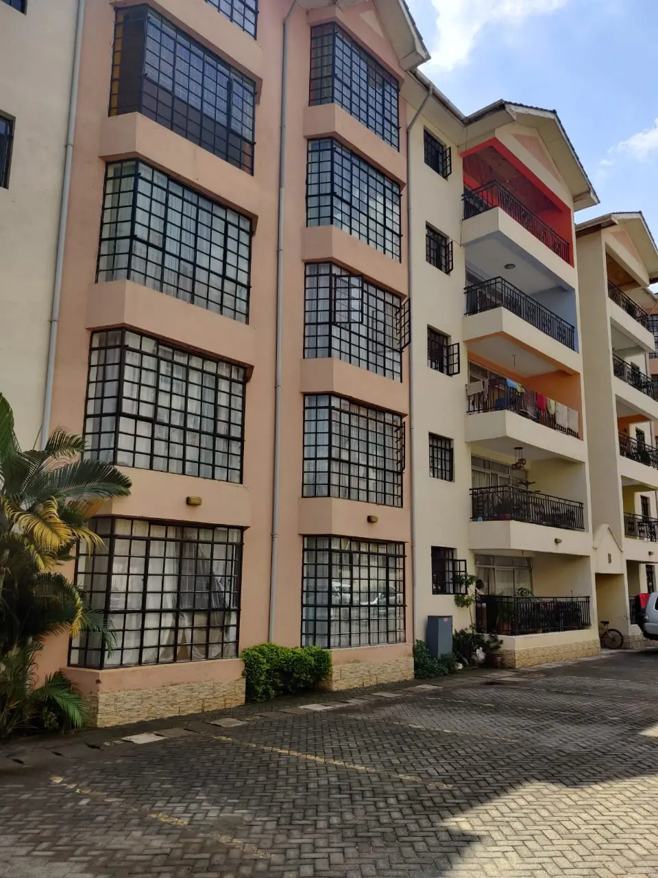Multi-story residential building facade with balconies and courtyard