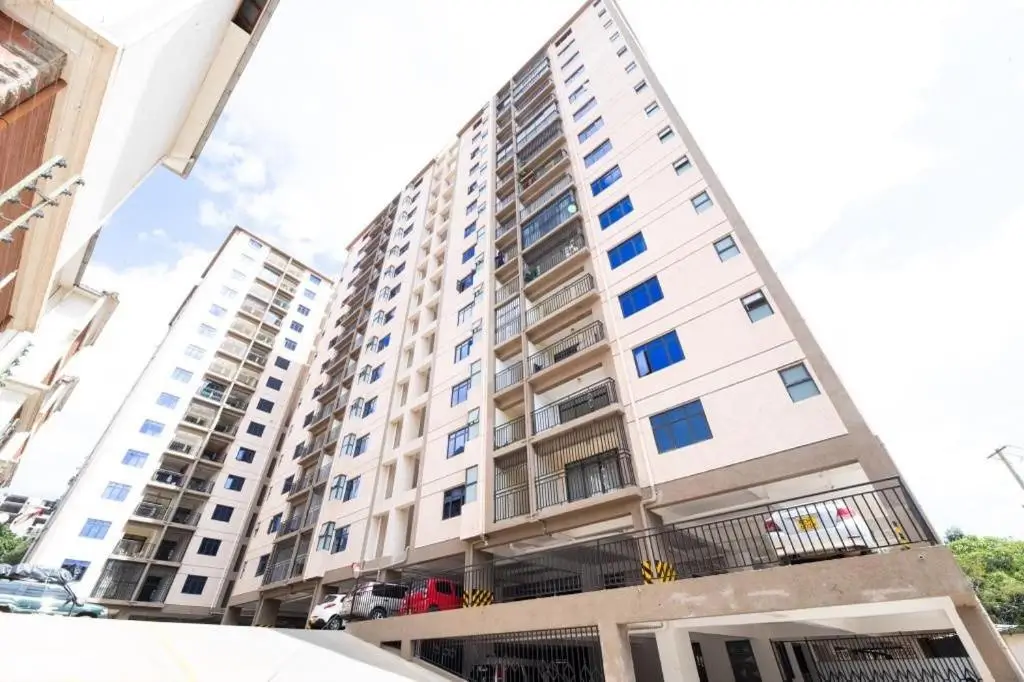 Multi-story residential building with ground-level parking garage