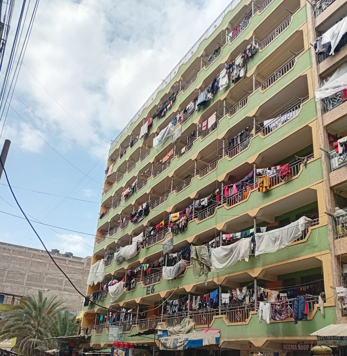 Multi-story residential building facade with balconies and clotheslines