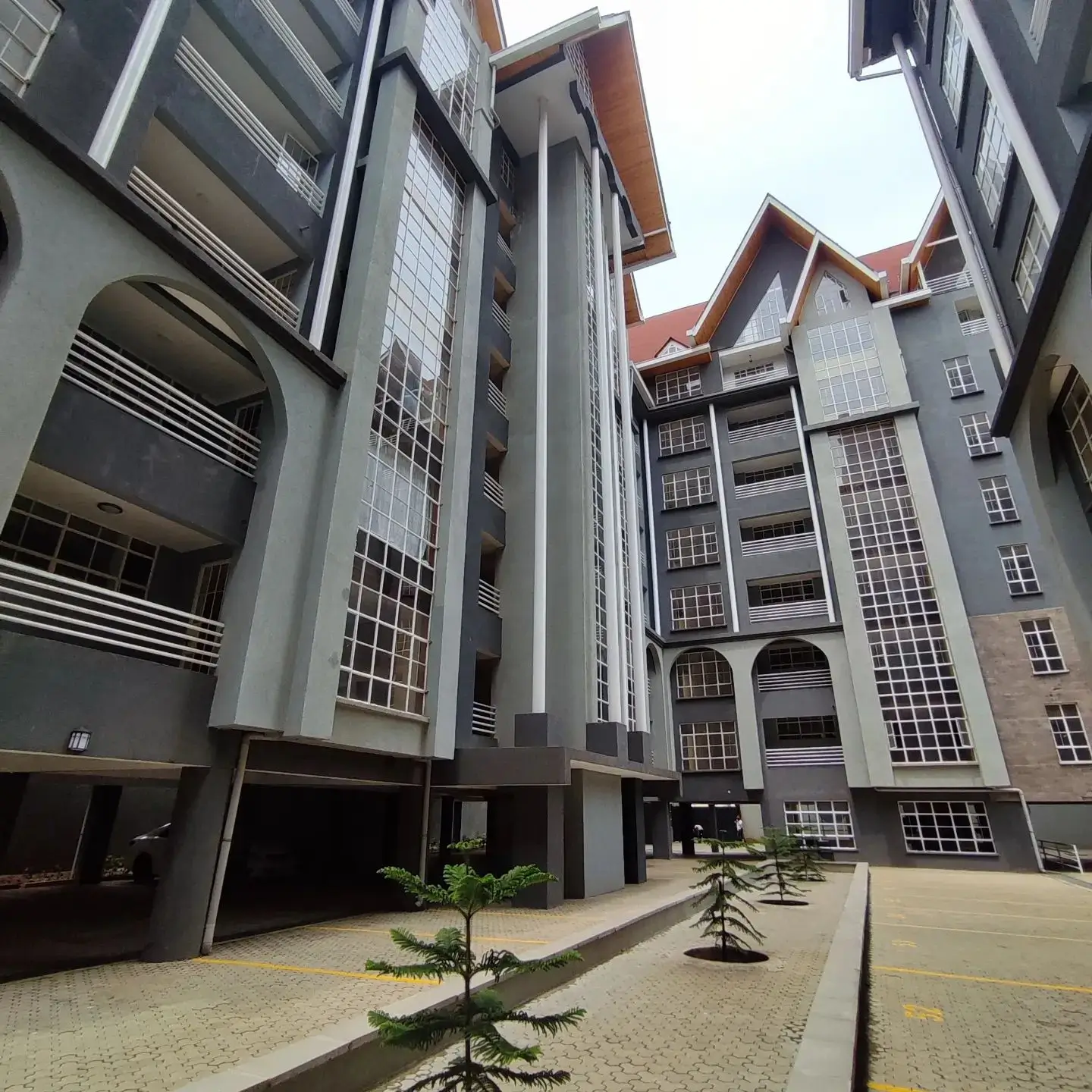 Modern multi-story residential complex with compound courtyard