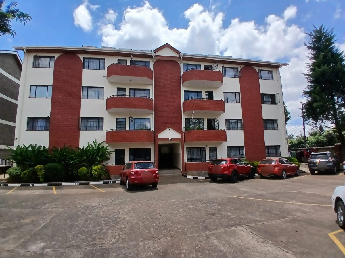 Multi-story residential building with red and white facade