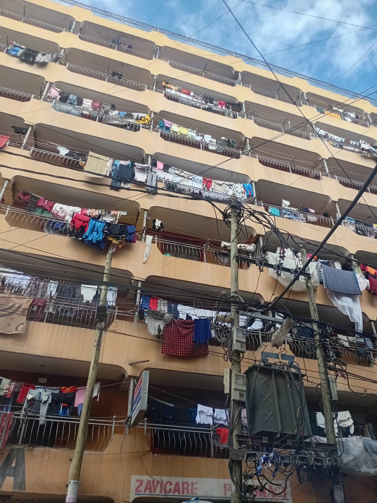 Multi-story residential building facade with laundry hanging