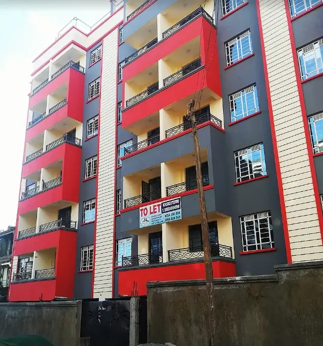 Modern residential building facade with red and yellow balconies