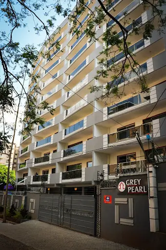 Multi-story residential building facade with balconies and gated entrance