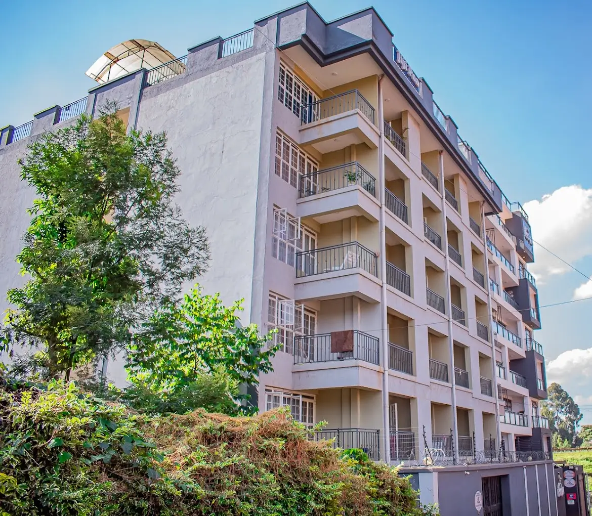 Multi-story residential building with balconies and landscaping