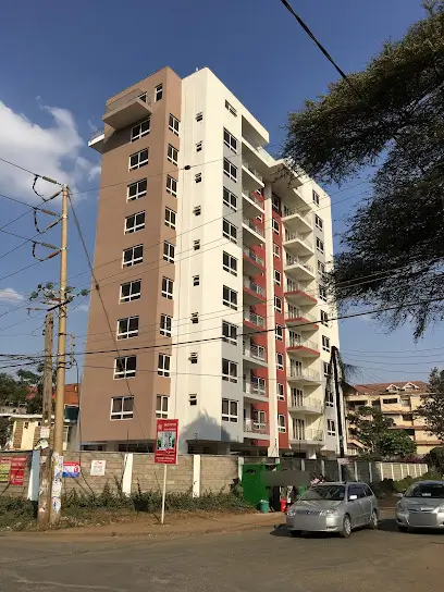 Multi-story residential building facade with balconies and parking