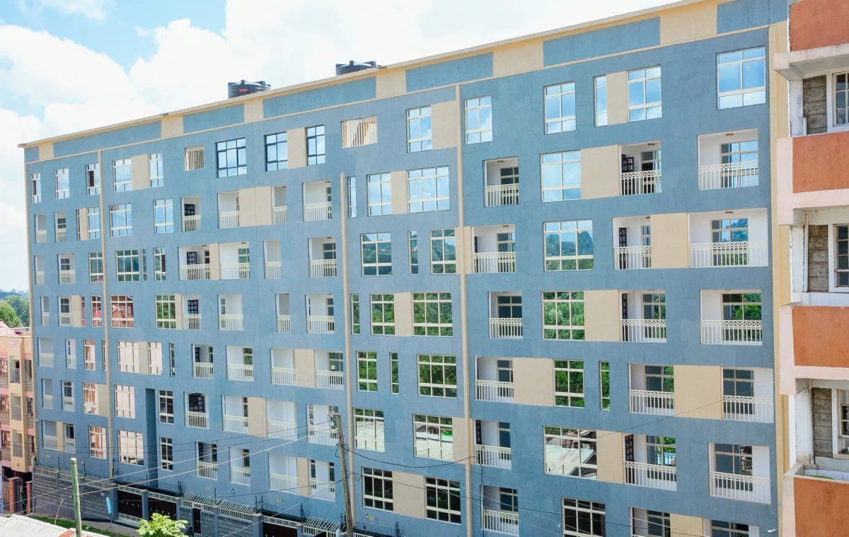 Multi-story residential building facade with colorful painted sections