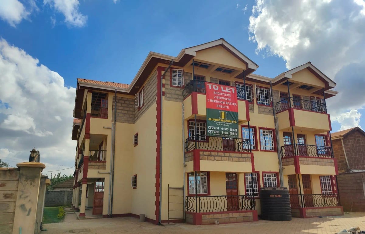 Multi-story residential building with yellow and red facade