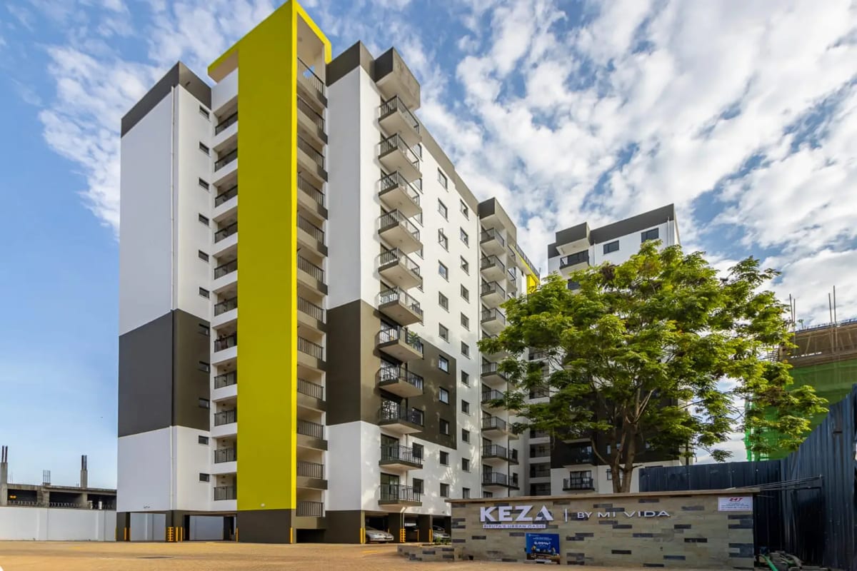 Modern multi-story residential building with yellow accent stripe