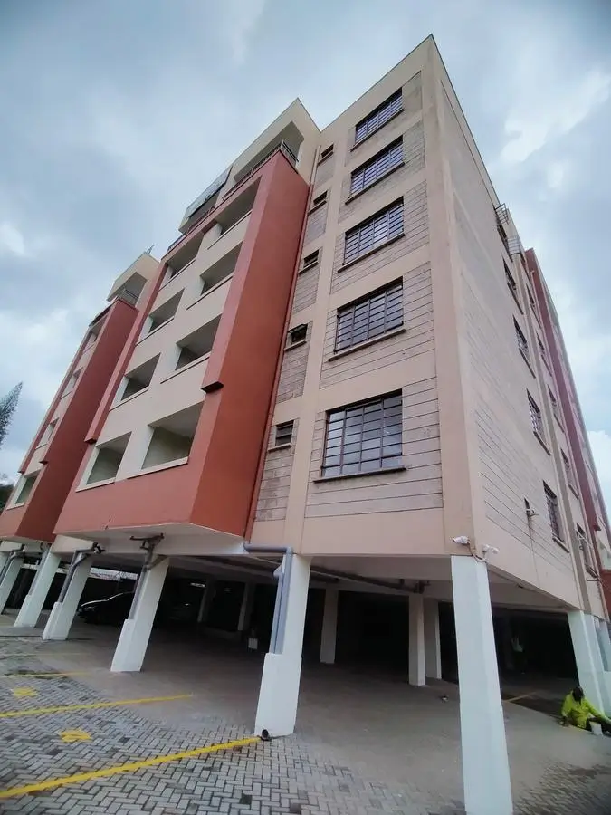 Modern multi-story residential building with ground-level parking