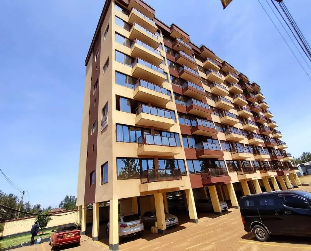 Multi-story residential building with ground-floor parking bays