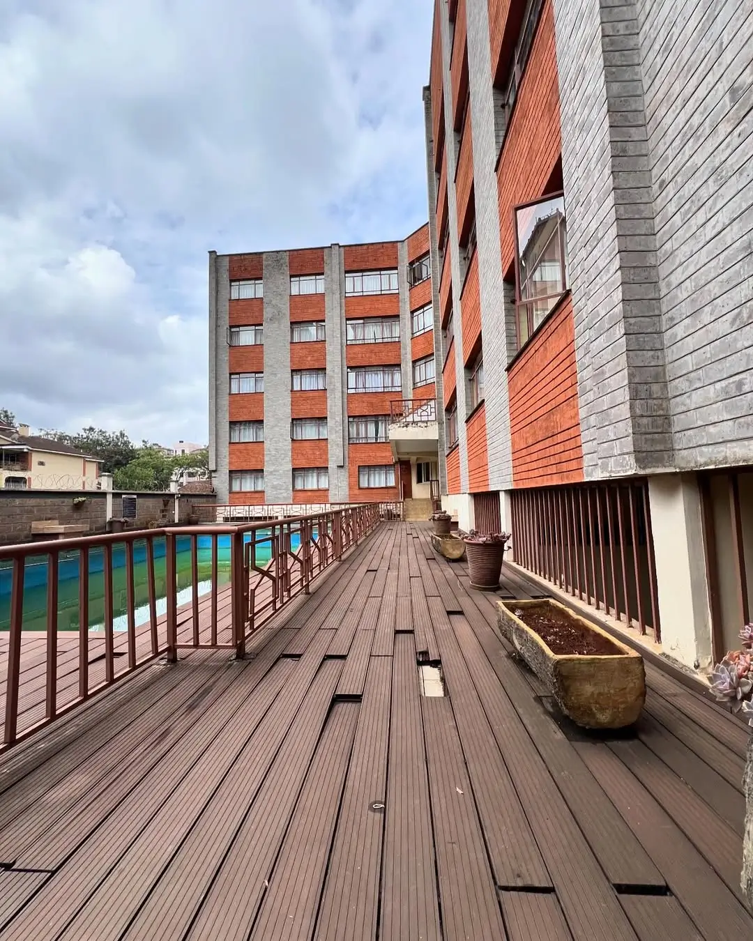Wooden deck terrace overlooking residential compound buildings